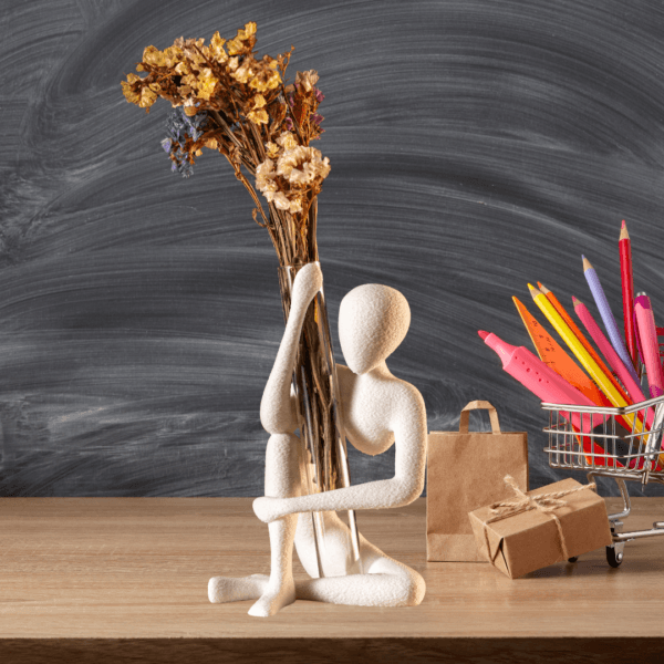 Sitting figurine vase holder – white minimalist human sculpture holding transparent bud vase with dried flowers 2
